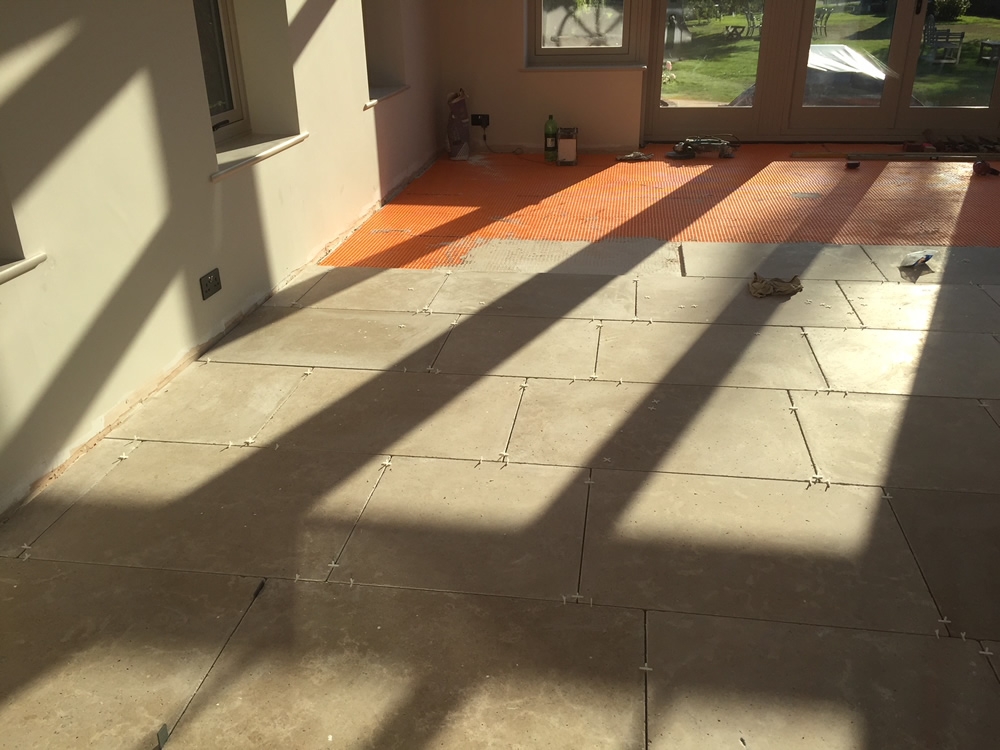 ORANGERY PROJECT STORY.  Orangery floor being laid with limestone tiles